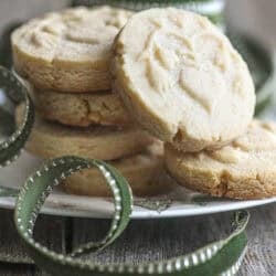 marzipan shortbread cookies with a spool of green Christmas ribbon.