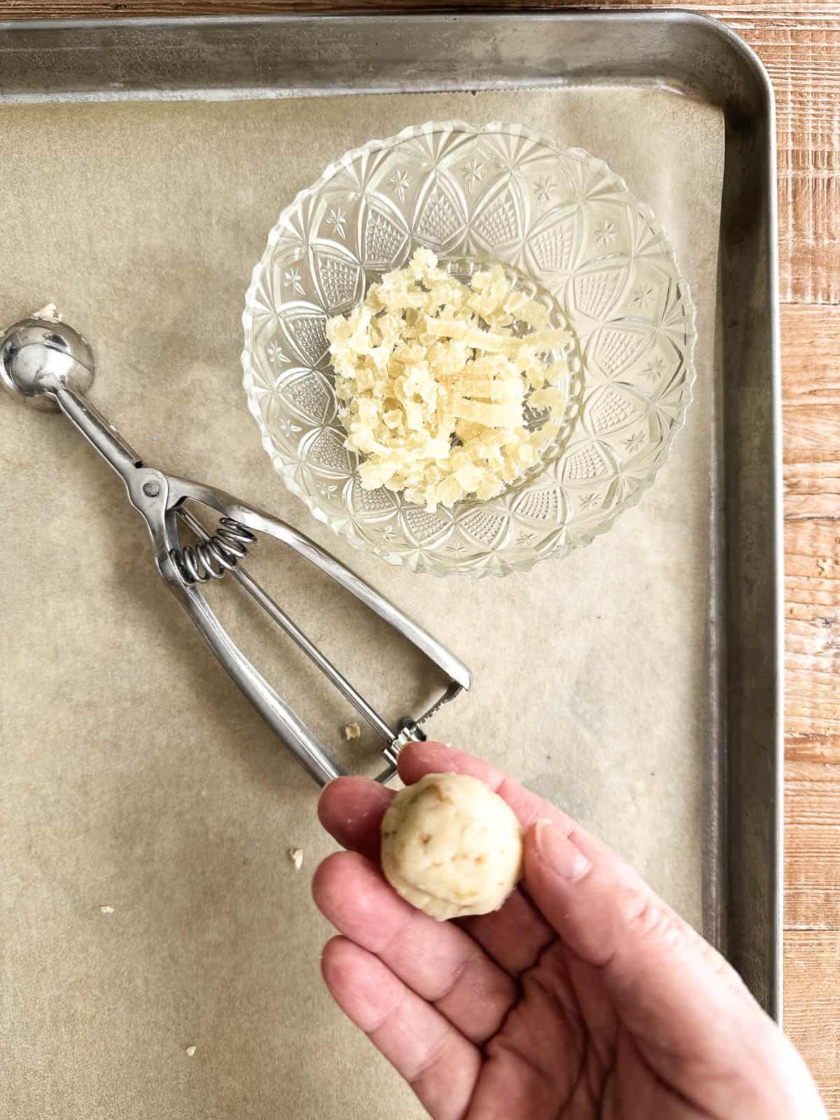 Making a ginger stuffed walnut ginger butter ball cookie.
