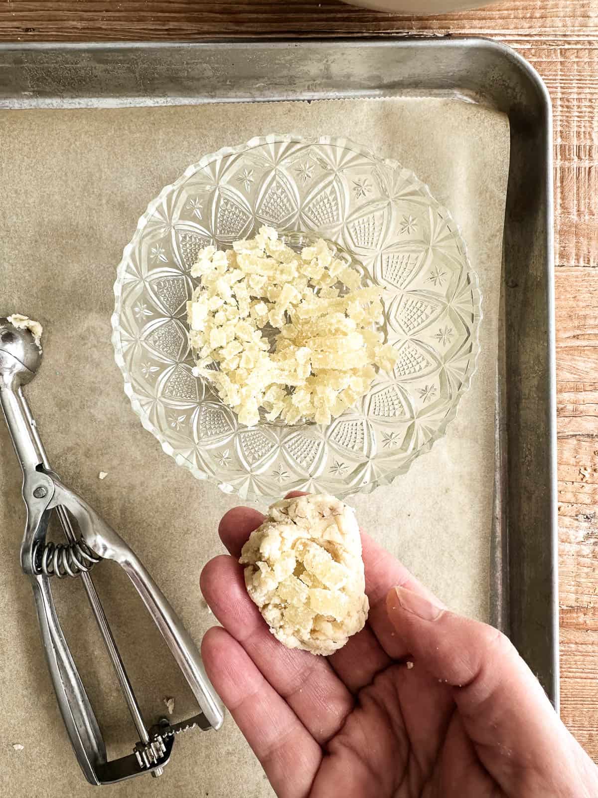 filling dough with candied ginger for walnut ginger butter balls.