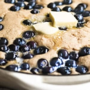 blueberry skillet pancake topped with melting butter.