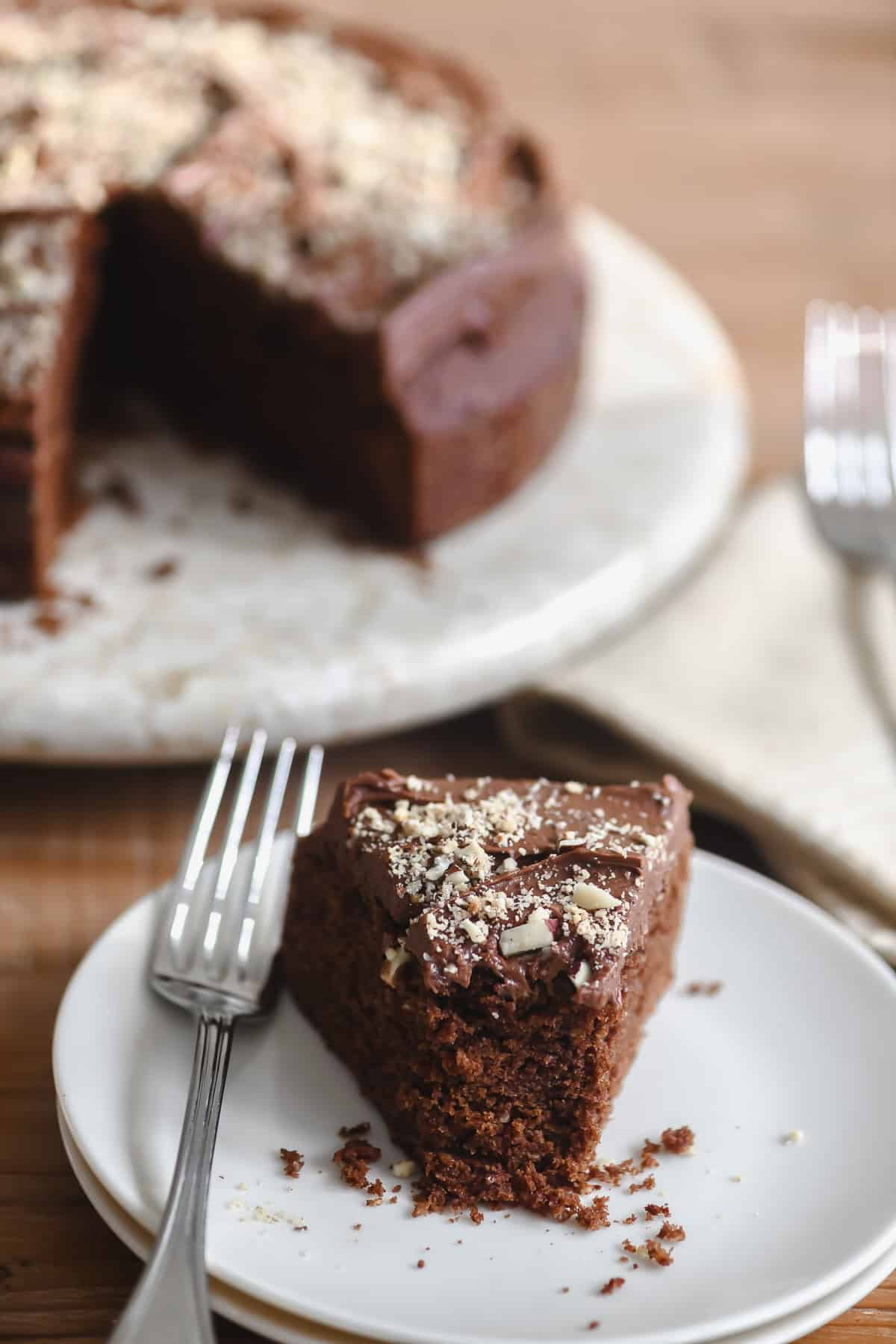 slice of dark chocolate hazelnut cake with bite taken.