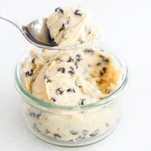 Taking a spoonful of safe edible cookie dough from a small dish.