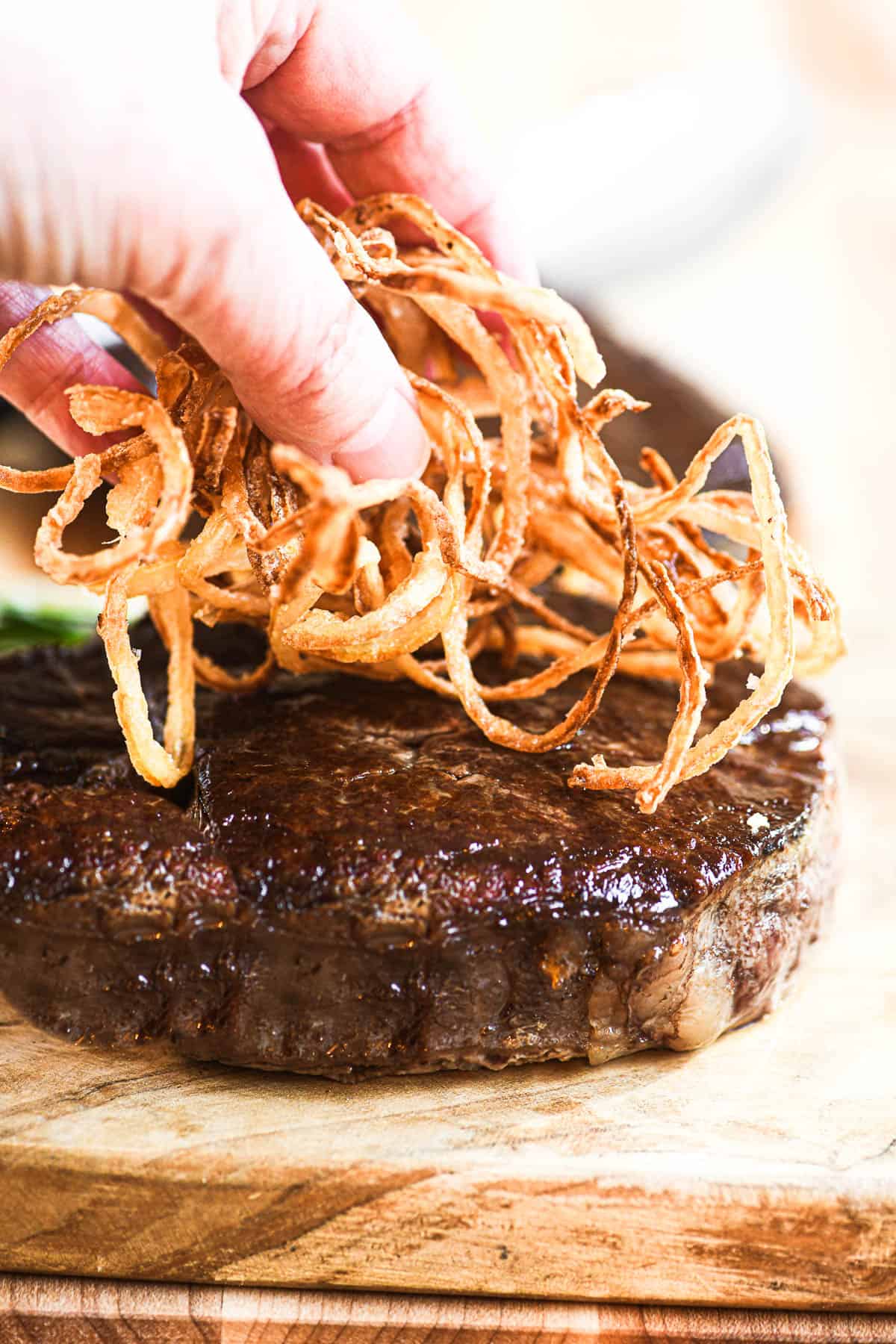 topping filet mignon with onion strings