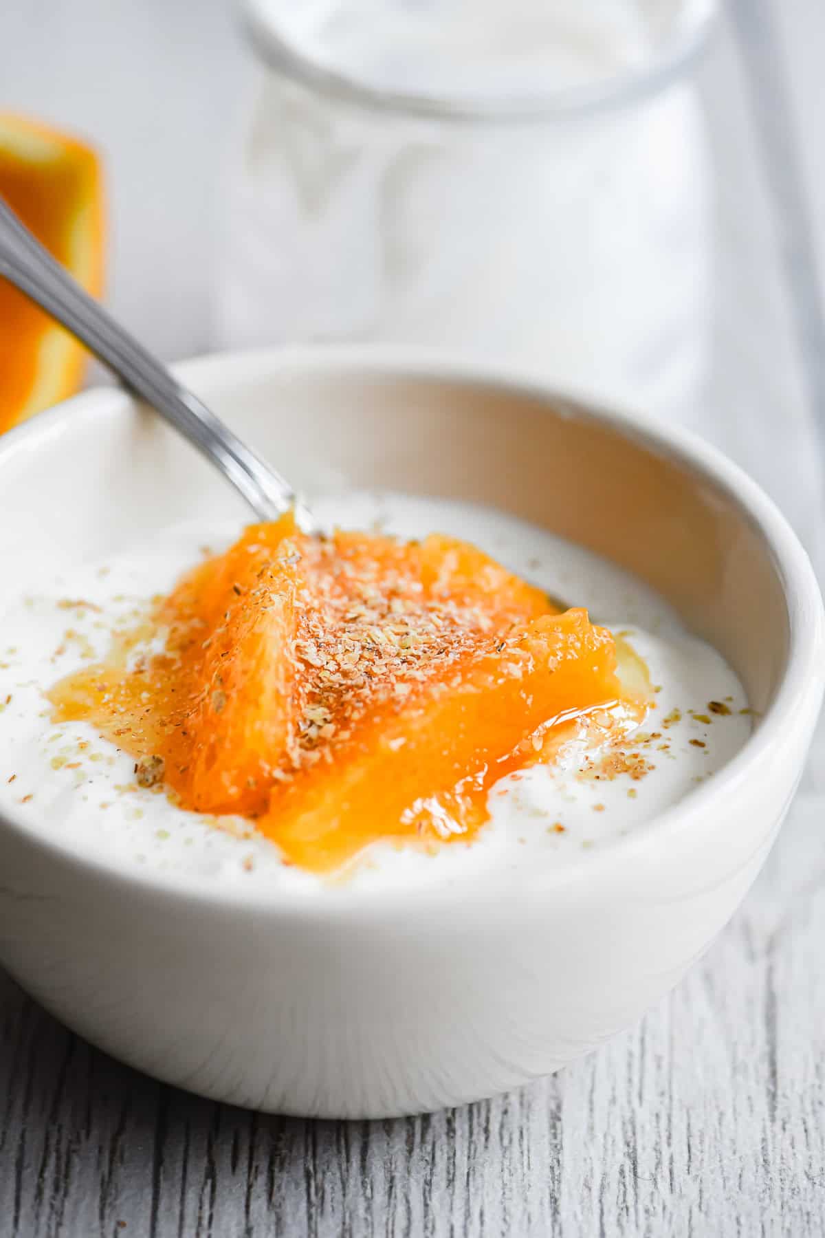 homemade yogurt topped with oranges, wheat germ, and honey.