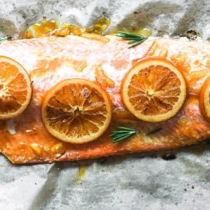 Marmalade glazed salmon topped with orange slices.