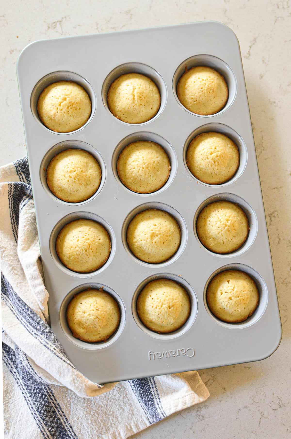 Madeleine muffins in a muffin tin.