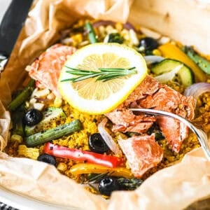 a colorful and healthy salmon and veggie parchment packet dinner.