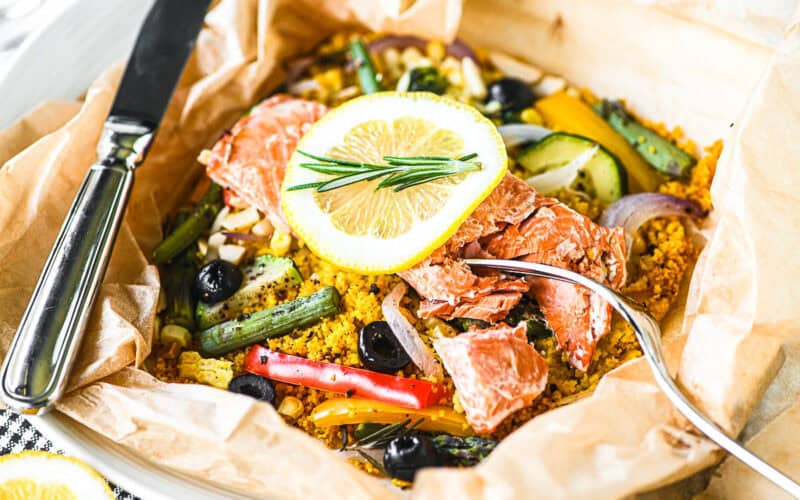 a colorful and healthy salmon and veggie parchment packet dinner.