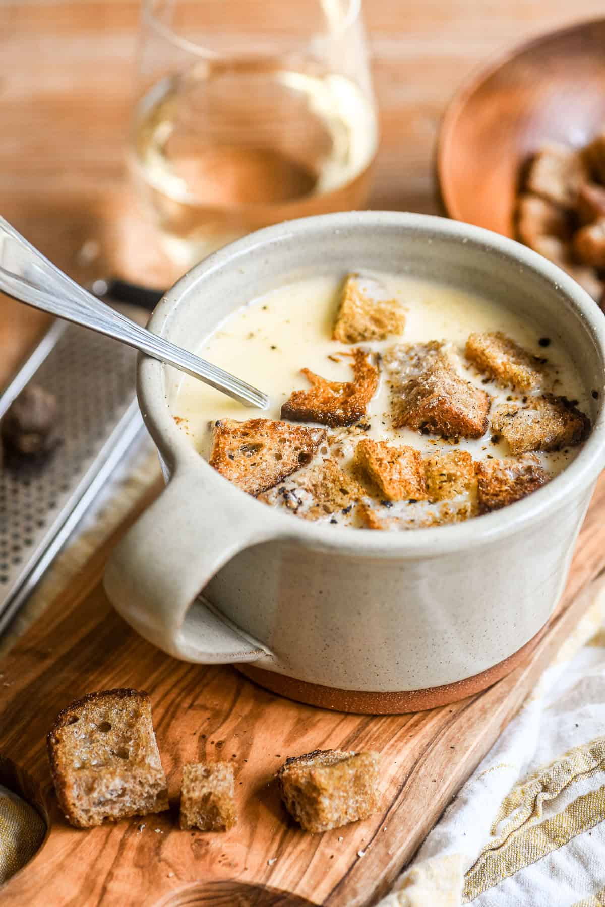cheese fondue soup in a mug with croutons.