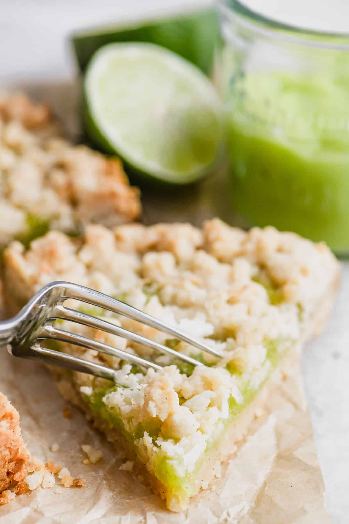 Taking a bite of a pretty slice of coconut lime shortbread tart.