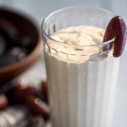 date shake smoothie in a tall glass.