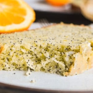 a slice of orange poppy seed bread with bite taken.