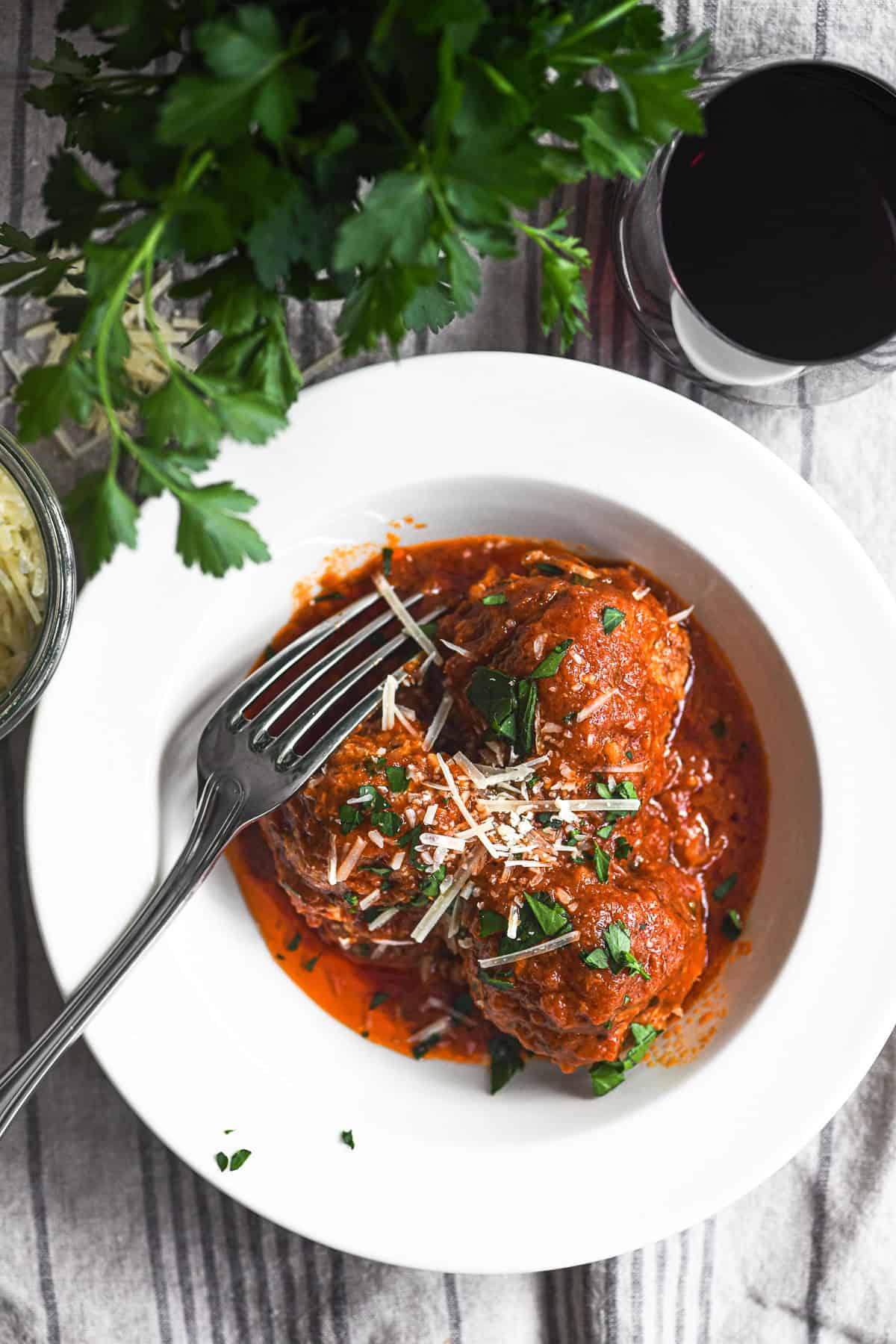 A small bowl of ricotta meatballs with sauce.