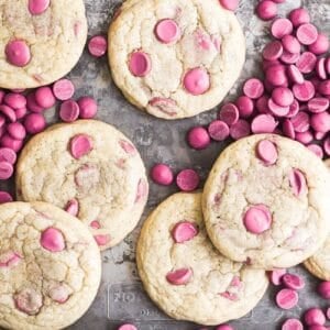 Ruby chocolate chip cookies on a sheet pan with ruby chocolate chips