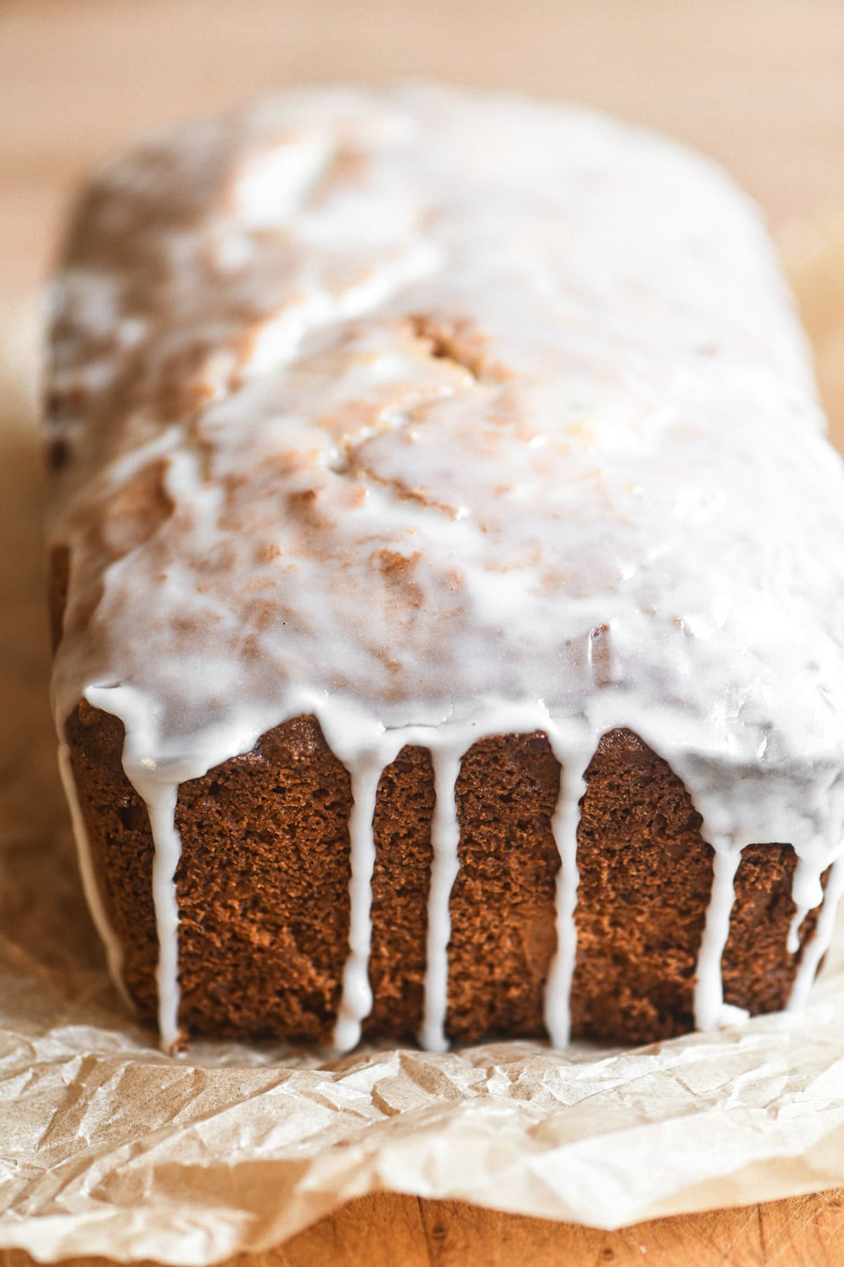 a loaf of pineapple banana bread with dripping glaze.