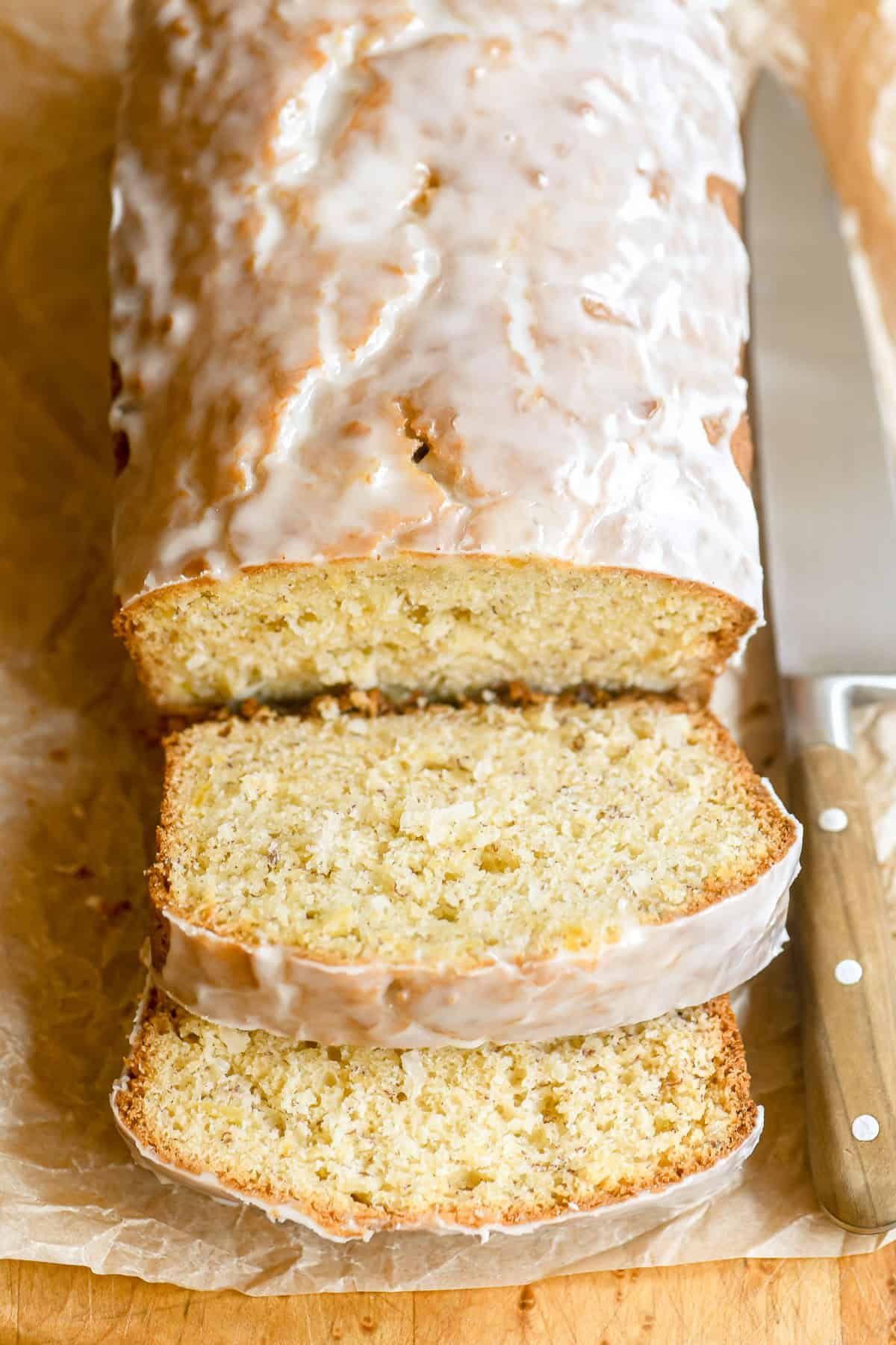 pineapple banana bread, sliced on a bread board.