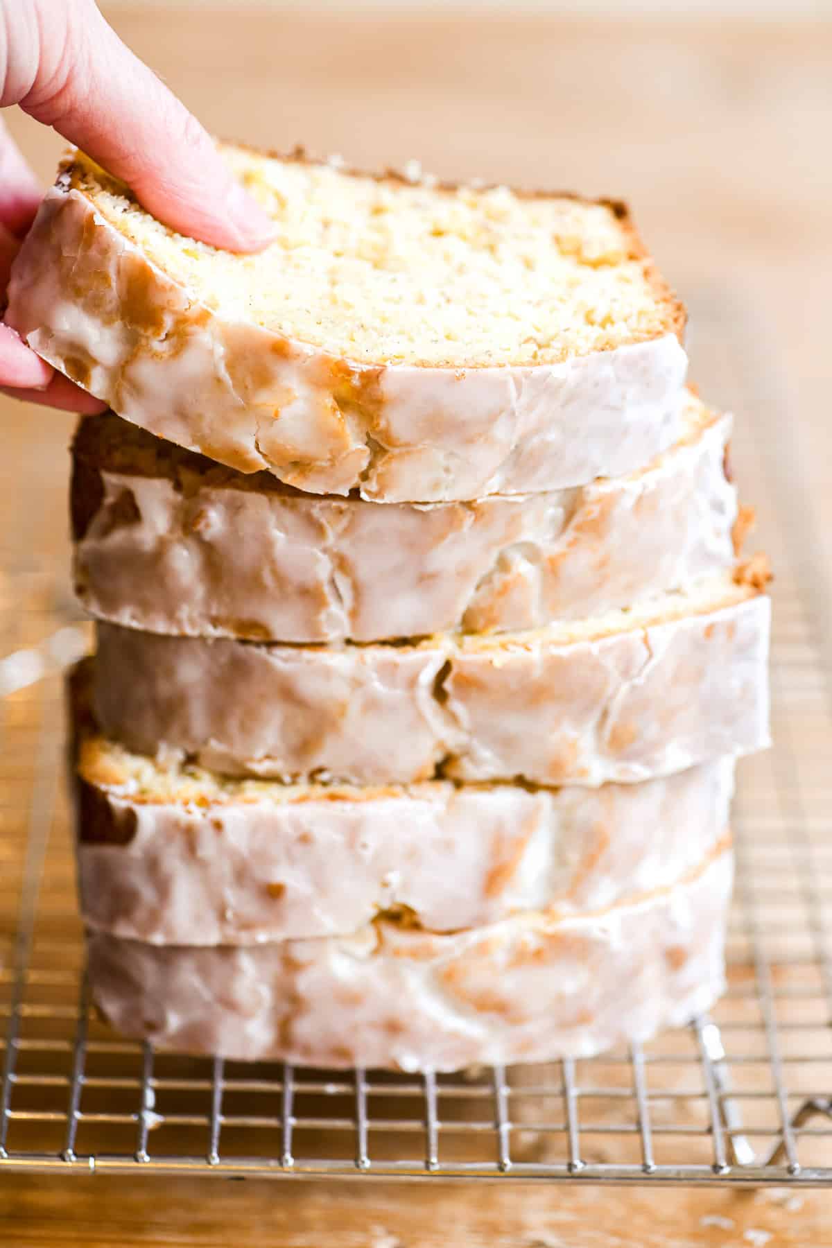 Slices of pineapple banana bread, stacked on a rack.