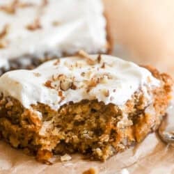 Carrot Cake bars, sliced and topped with cream cheese frosting and toasted pecans.