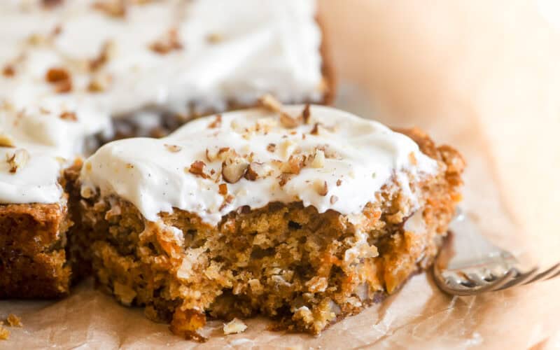 Carrot Cake bars, sliced and topped with cream cheese frosting and toasted pecans.