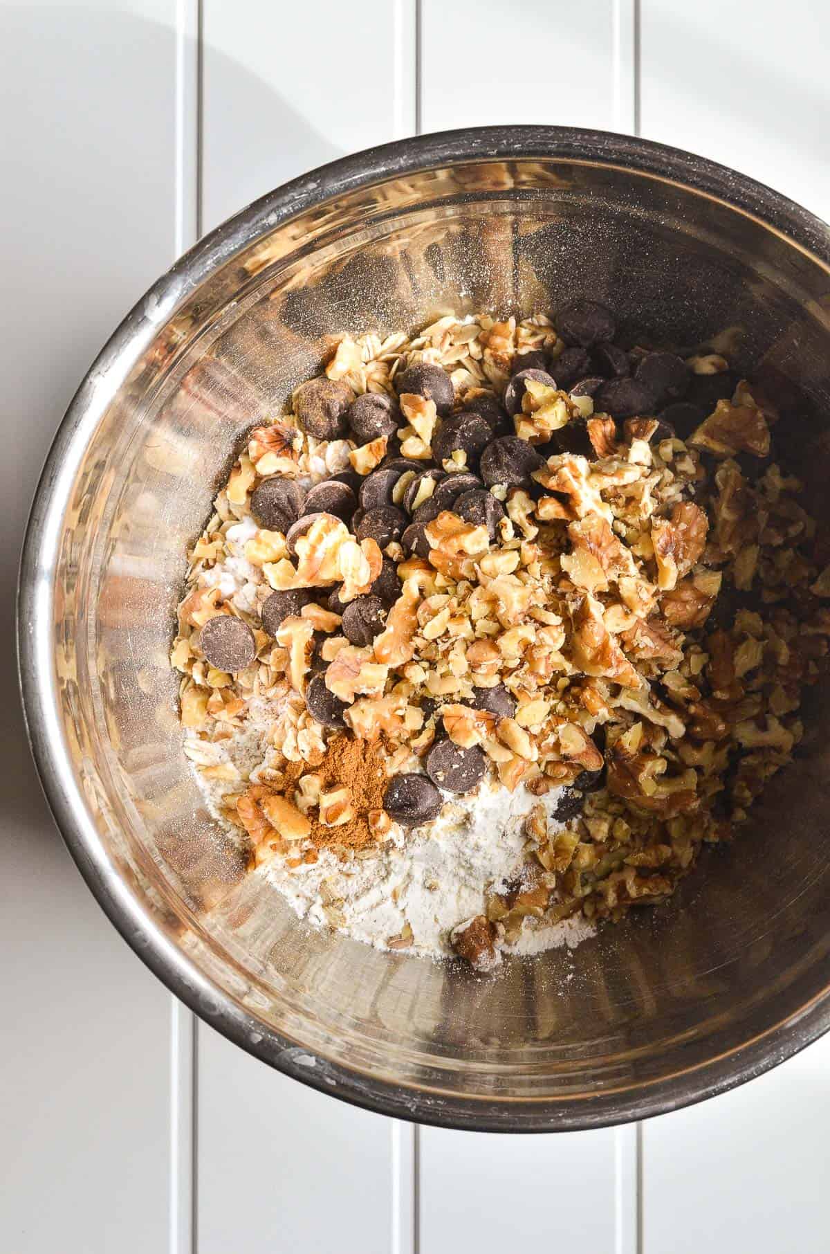 Dry ingredients in a bowl for chocolate chip oatmeal cookie bars.