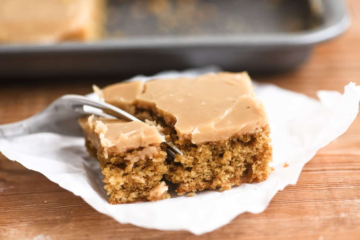 a slice of Mary Berry's coffee fudge traybake on parchment paper.