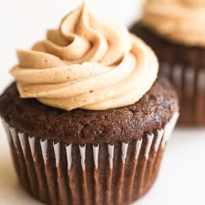 peanut butter buttercream piped on a chocolate cupcake.
