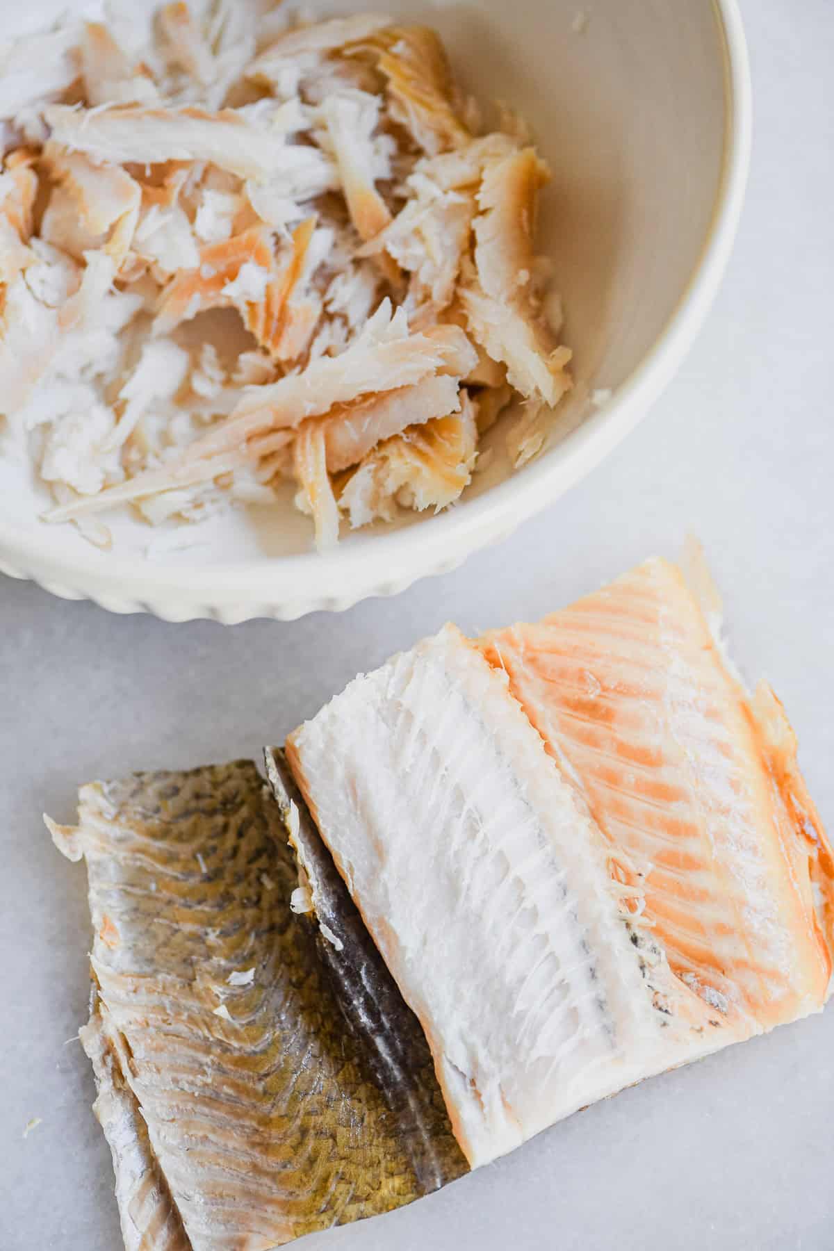 smoked whitefish being deboned and flaked for salad.