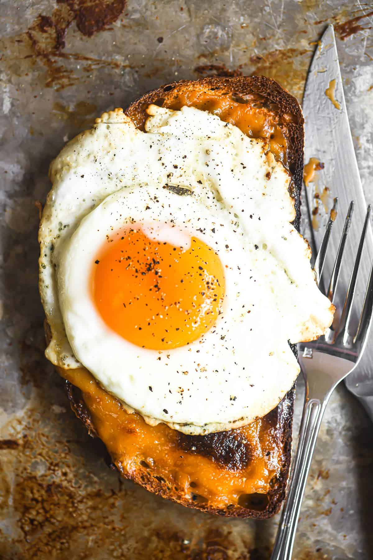 Welsh Rarebit topped with a sunny-side up egg.