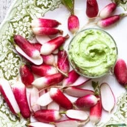 French breakfast radishes on a platter with tarragon butter.