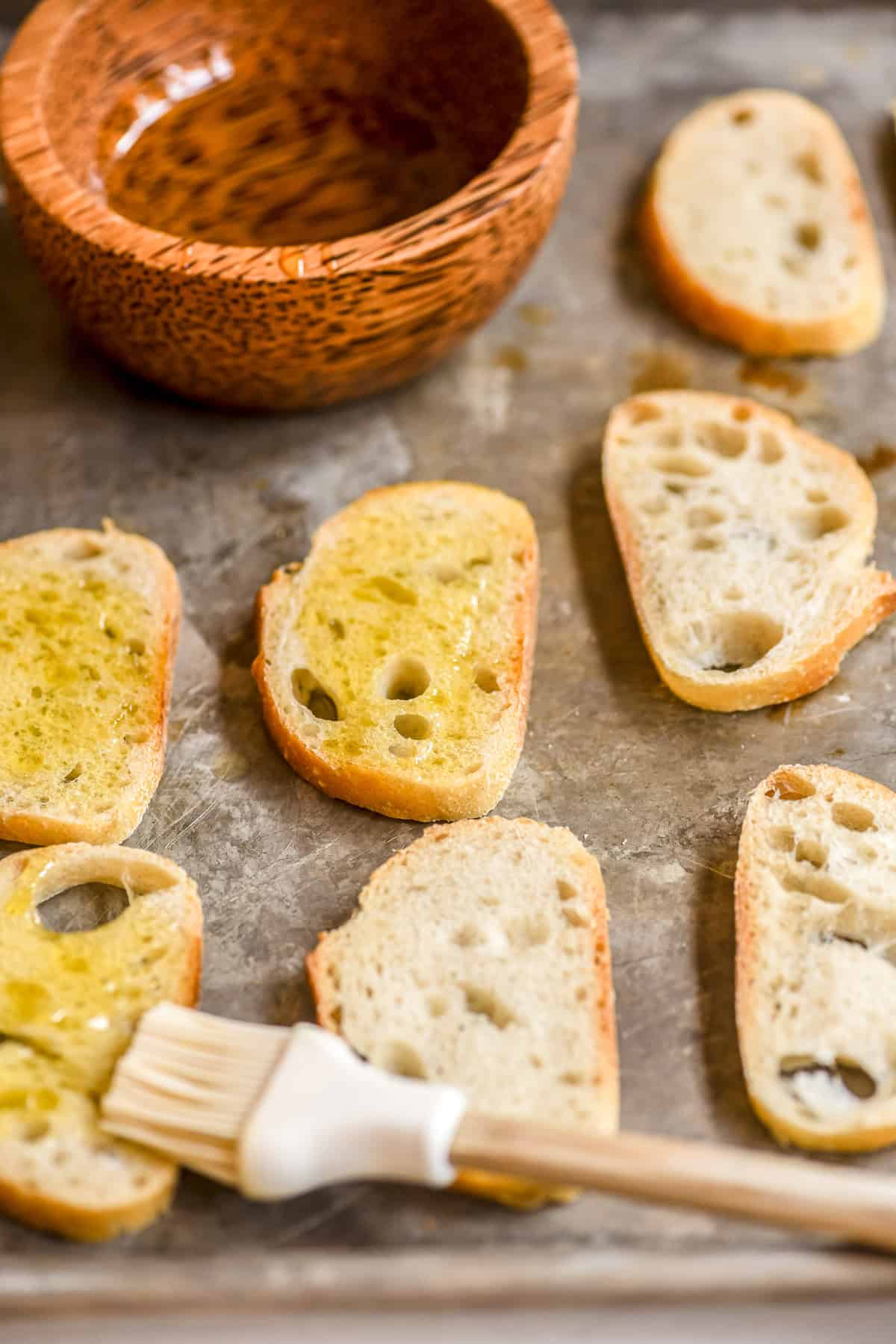 brushing thin slices of bread with olive oil for toasting.