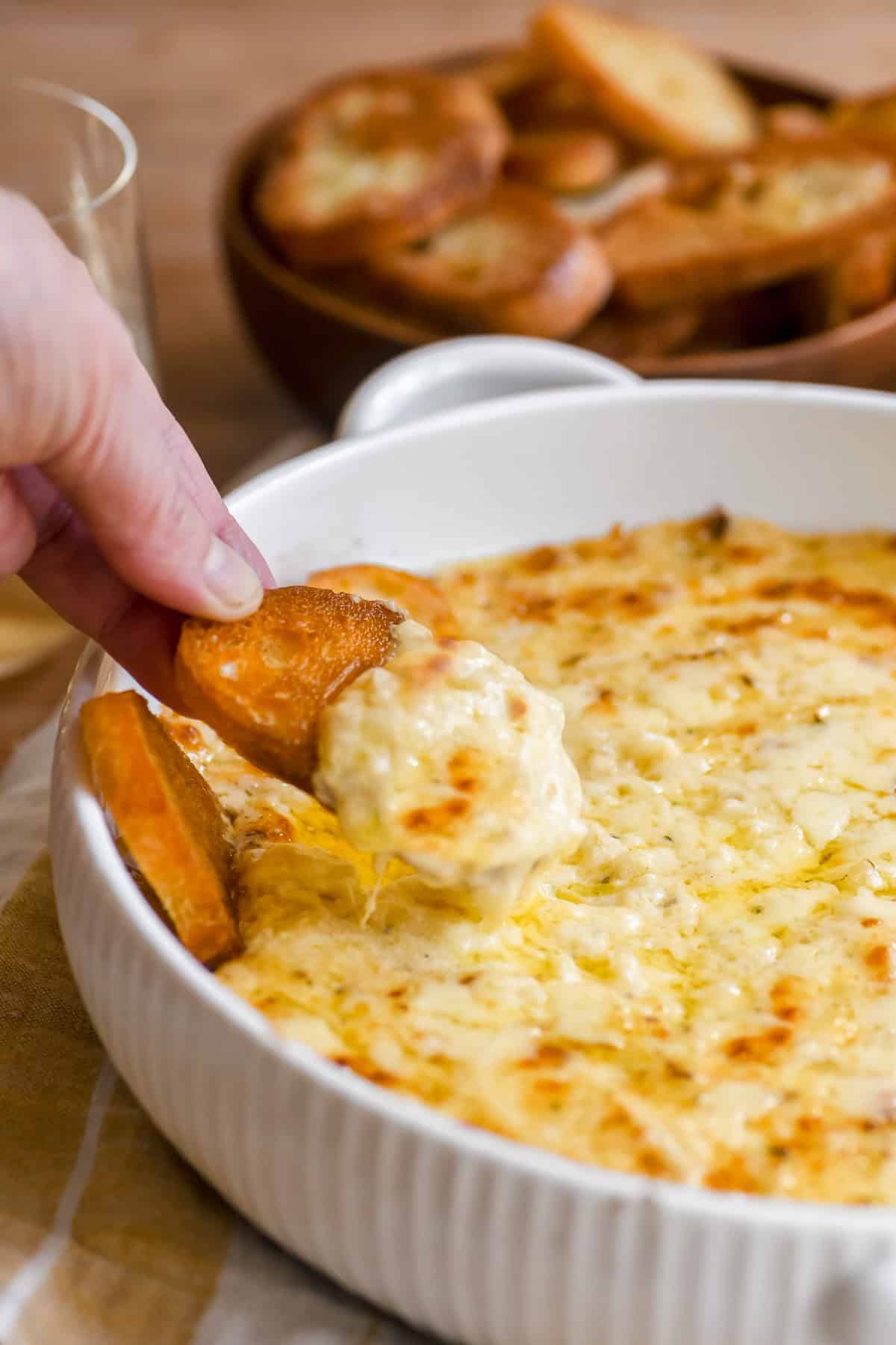 Dipping toasted bread into Vidalia onion dip.