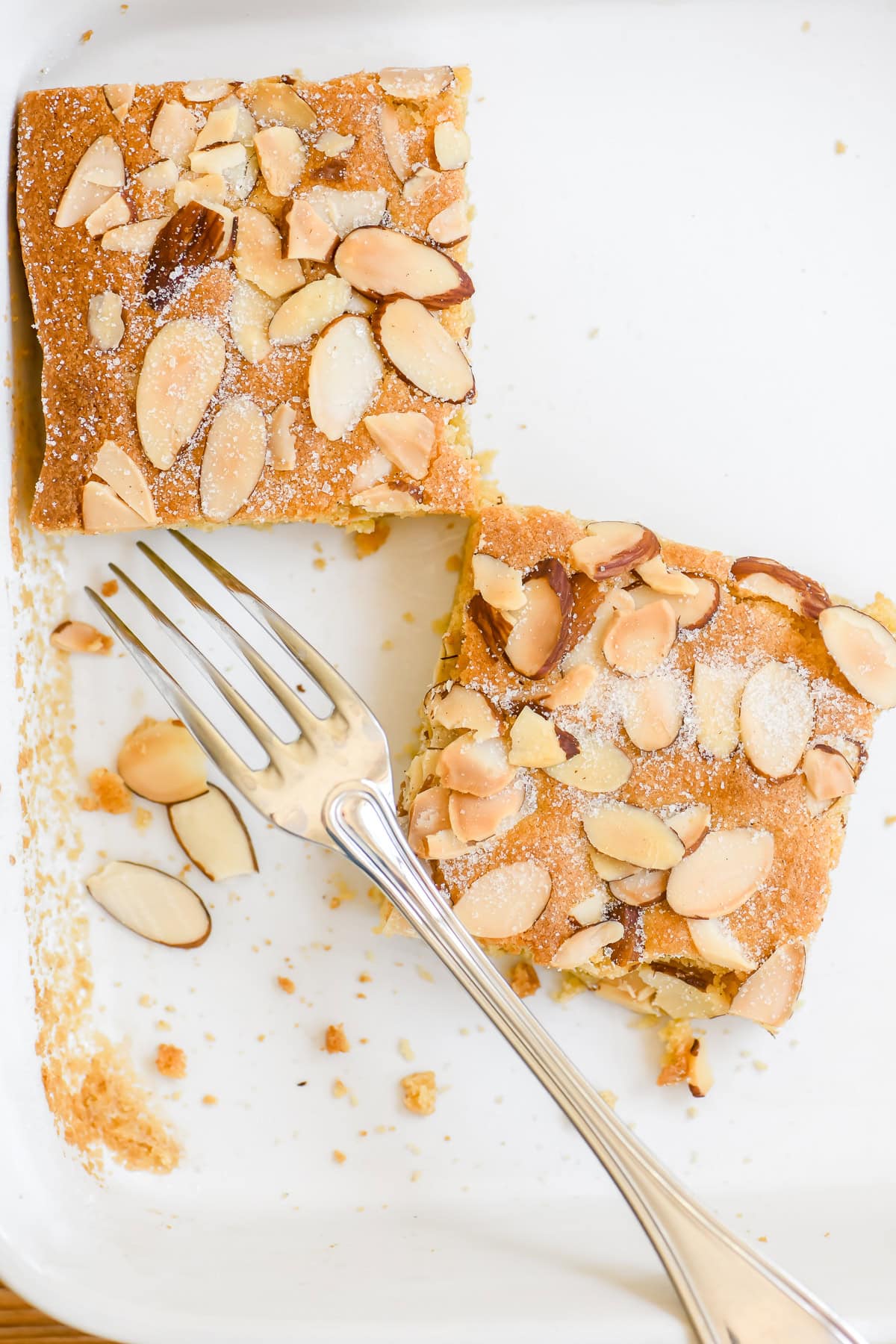 last two almond brownies left in the pan.