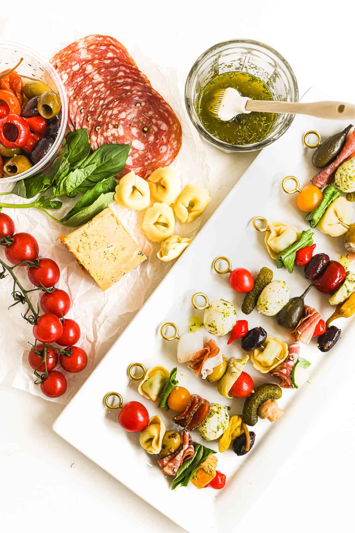 Colorful antipasto skewers on a platter with all the fixings.