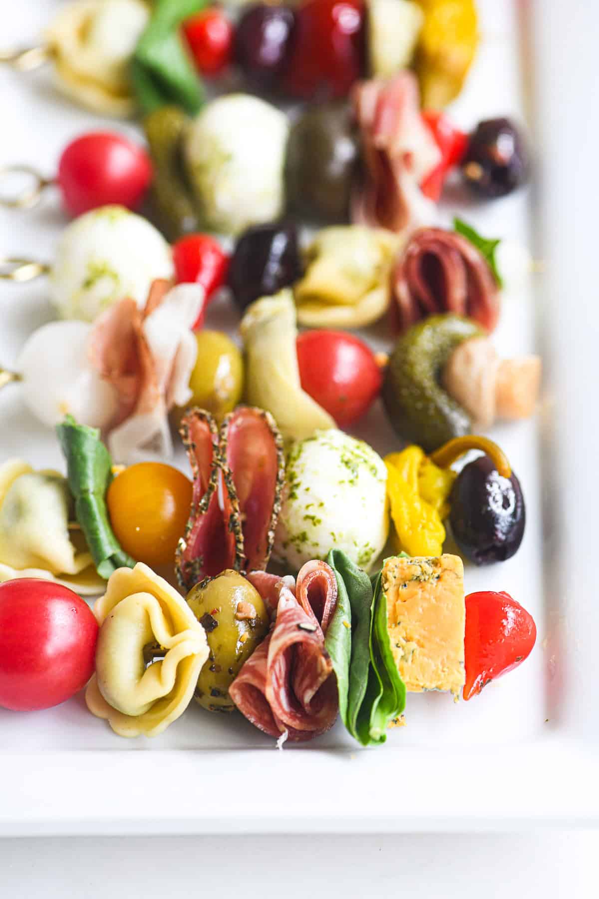 Colorful antipasto skewers on a platter.