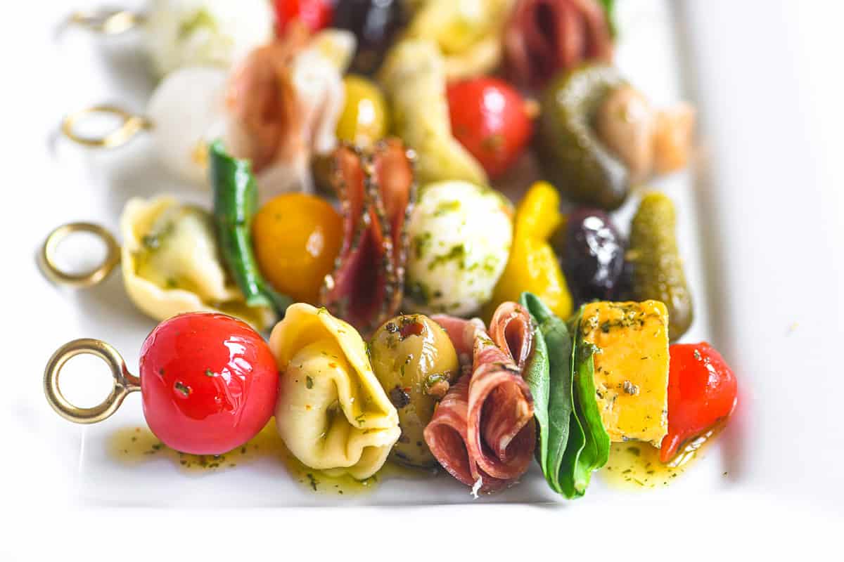 Antipasto skewers with olives, tomato, tortellini,, cheese, and meats.