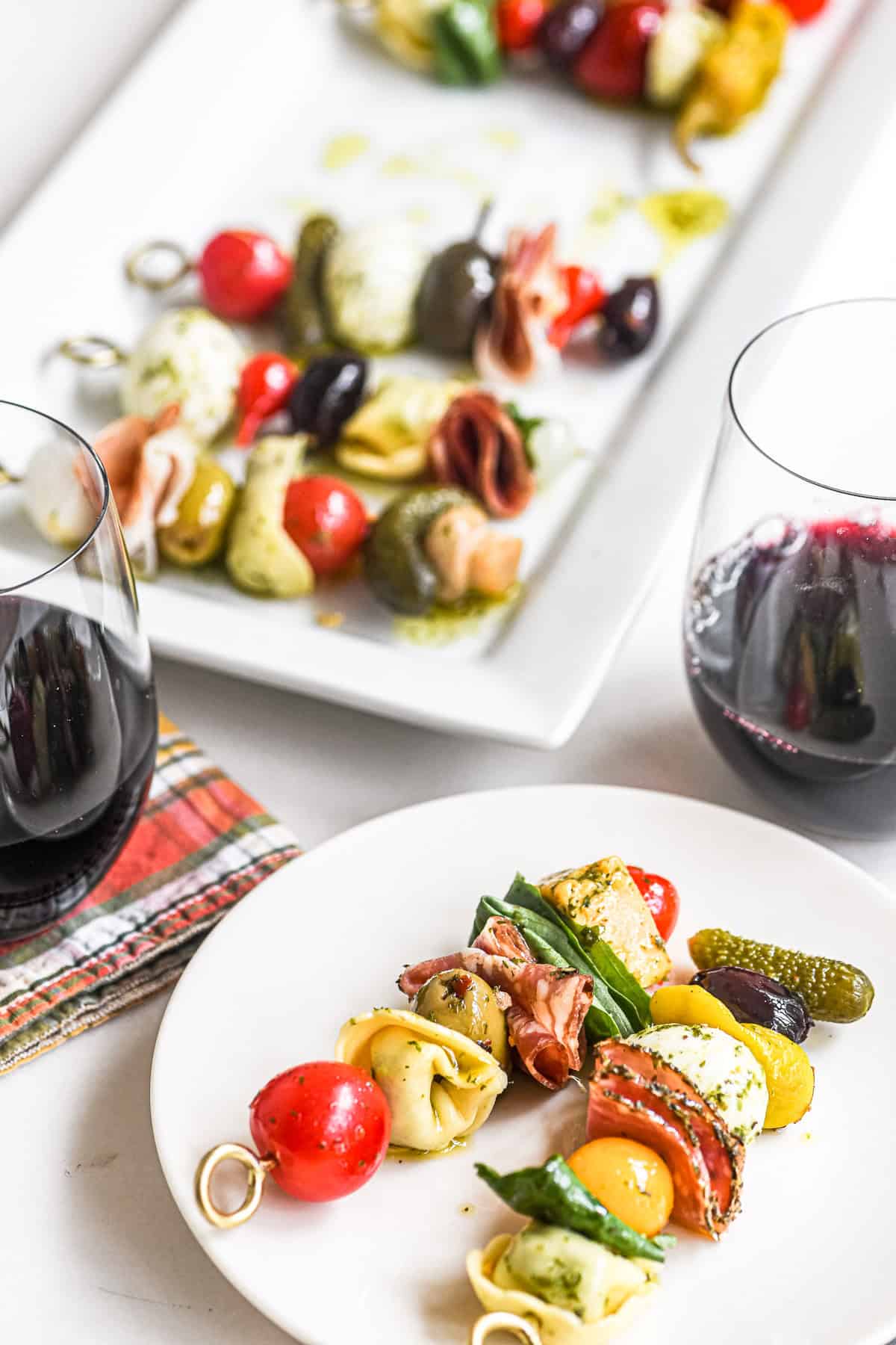 antipasto skewers appetizer platter with wine.