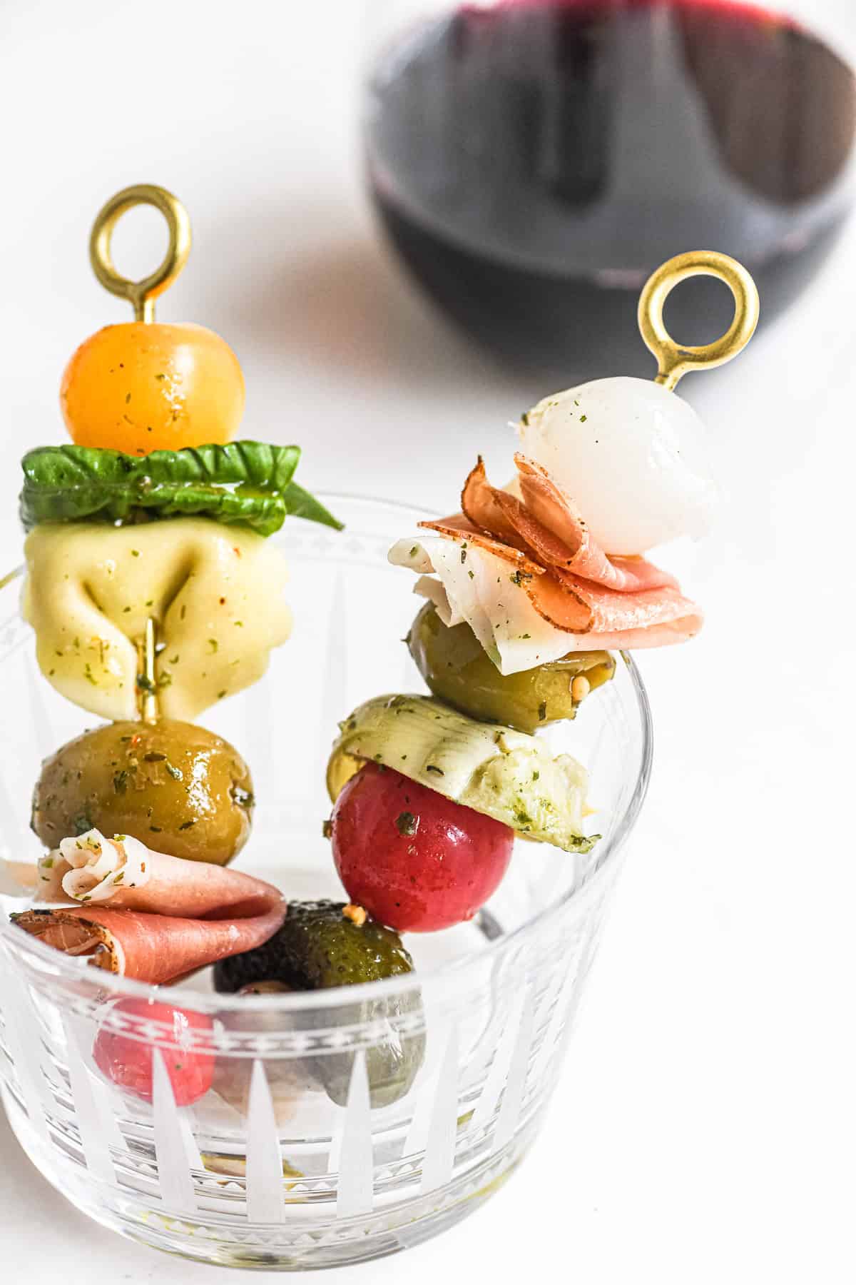 antipasto skewers in a glass, with wine.