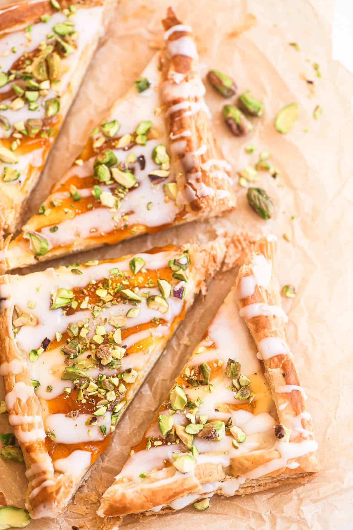 apricot pistachio puff pastry danish sliced into triangles.