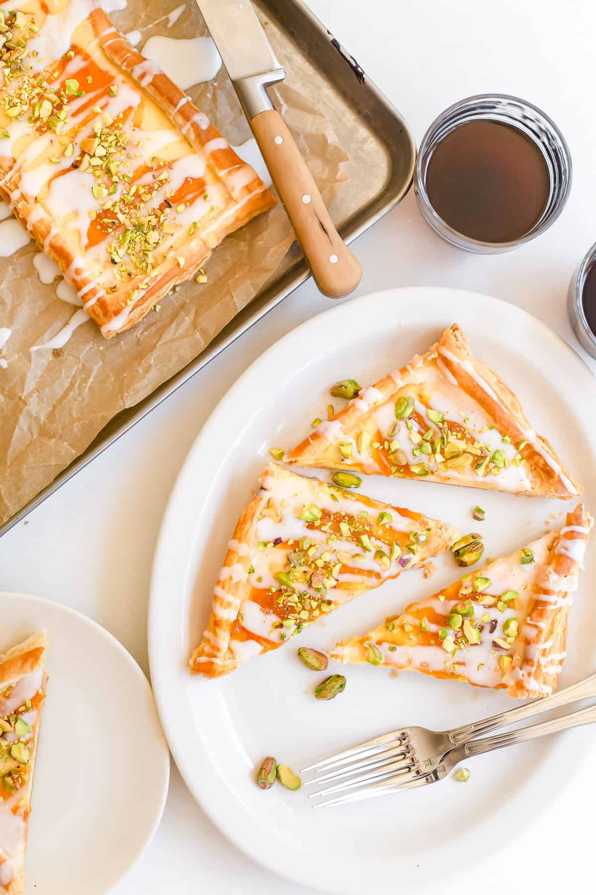Apricot and pistachio puff pastry sliced and placed on q platter. with coffee.