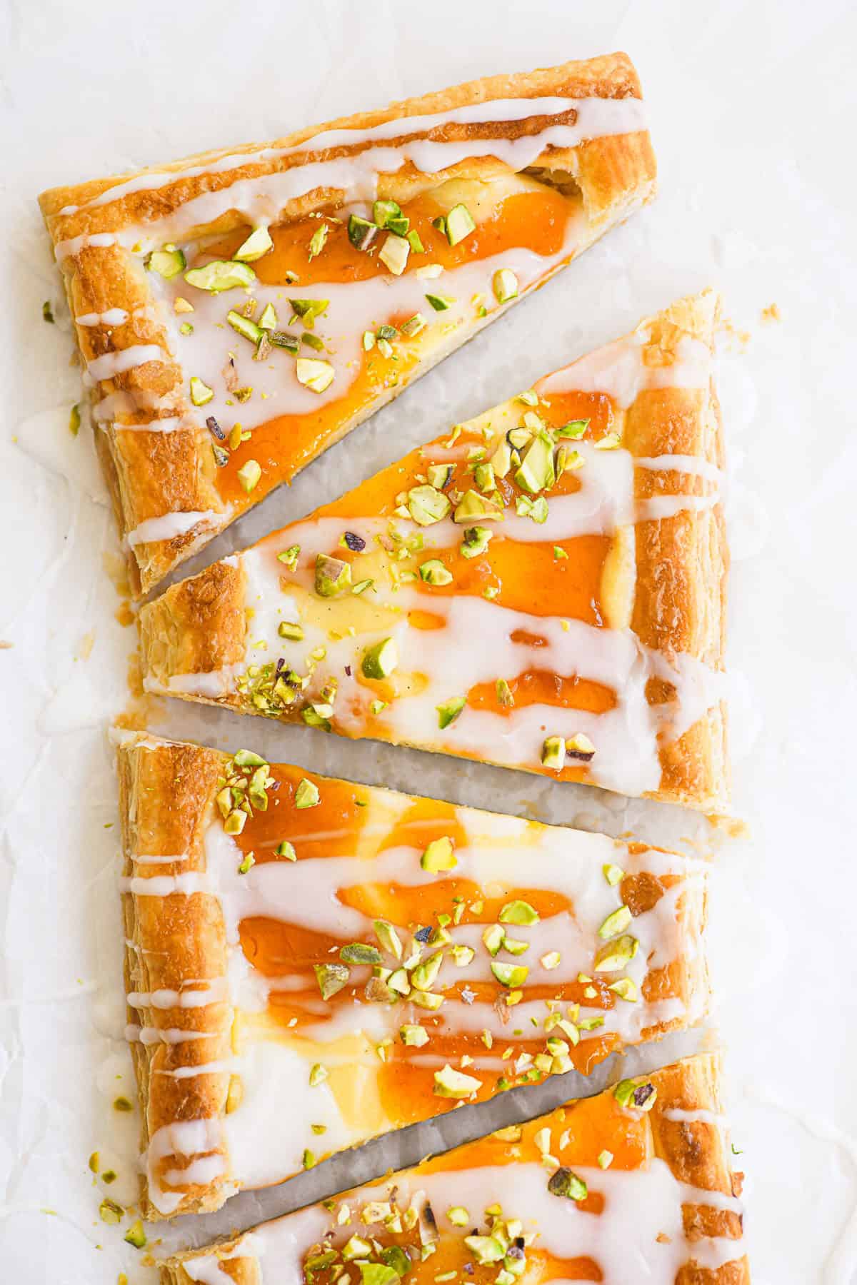 apricot pistachio puff pastry Danish sliced into wedges.