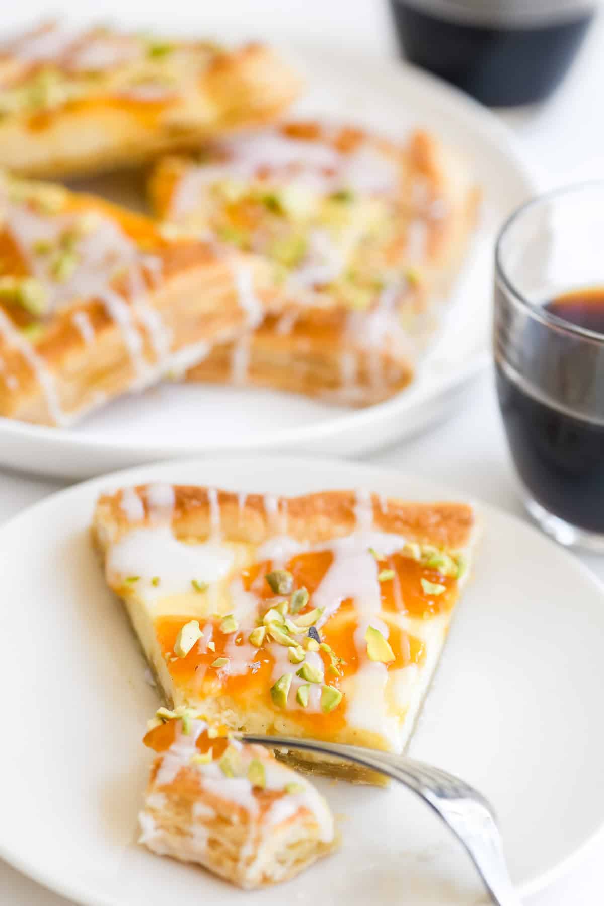 Apricot and pistachio puff pastry sliced and placed on q platter. with coffee.