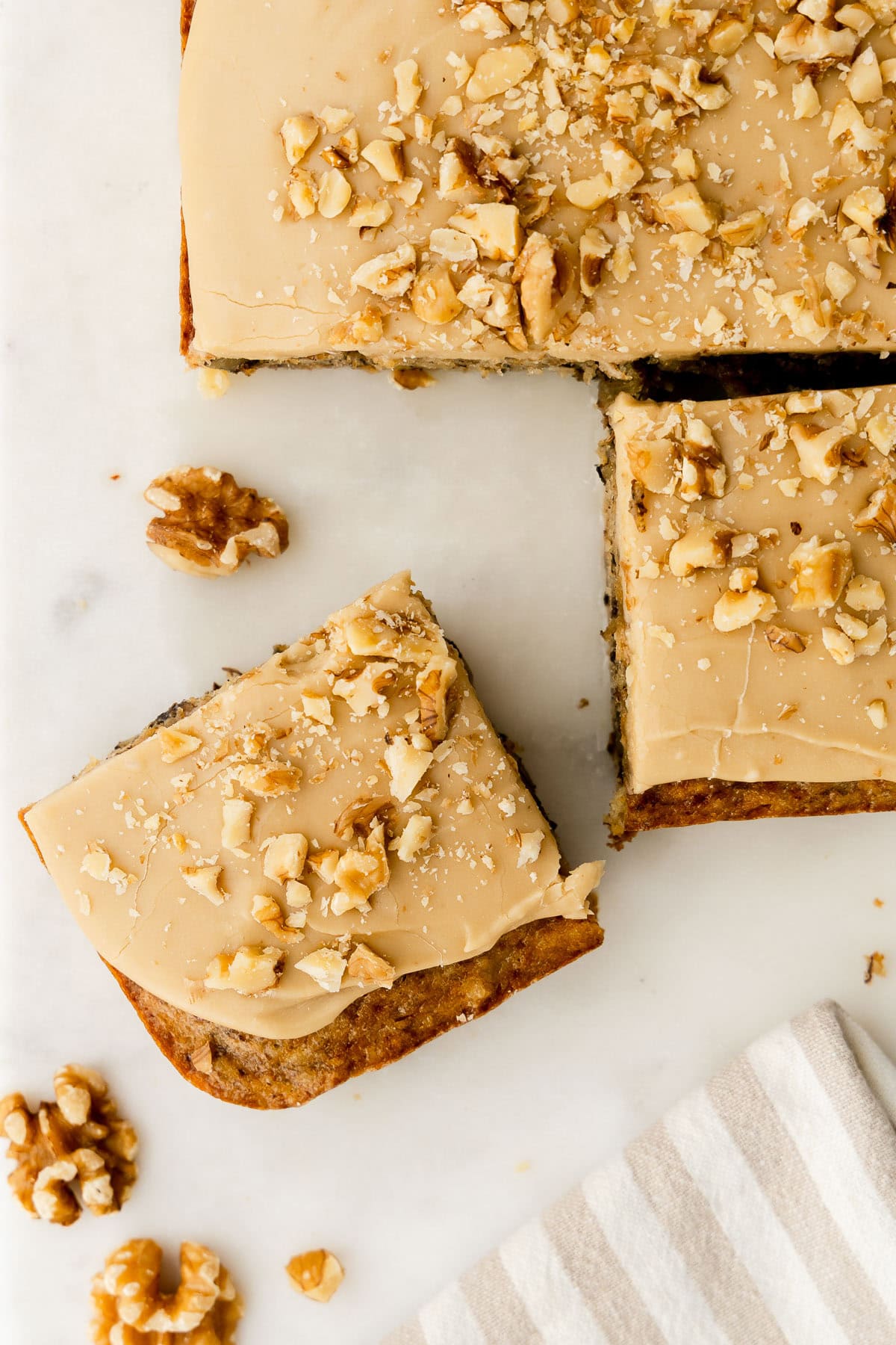 Banana walnut cake sliced into squares.
