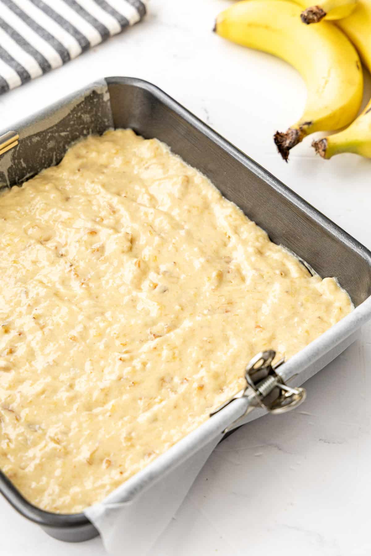 banana walnut cake batter in pan.