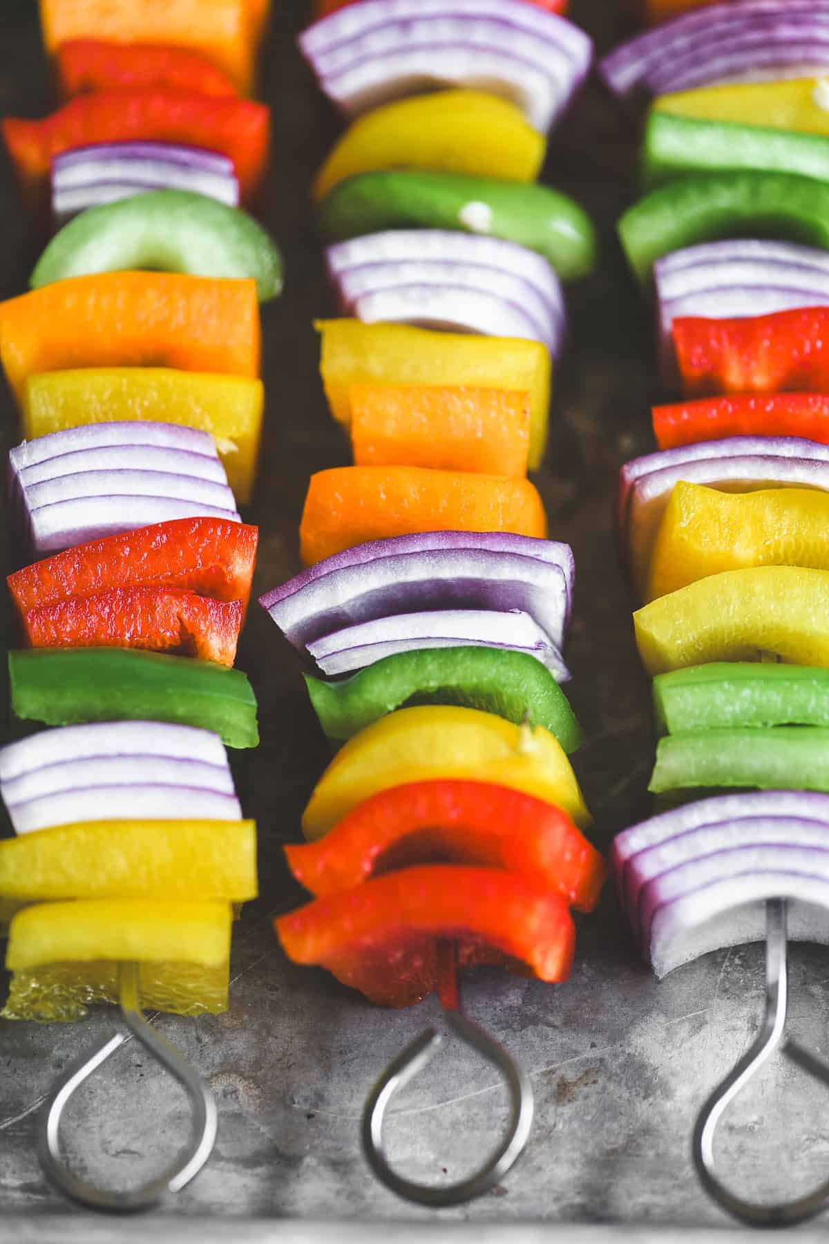 bell peppers and red onion threaded onto skewers.