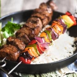 fajita skewers on a bowl of rice.