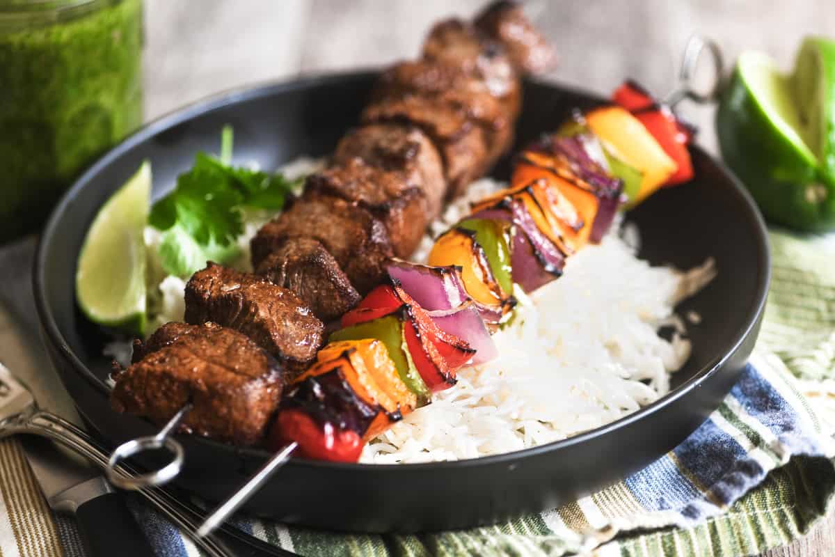 fajita skewers on a bowl of rice.
