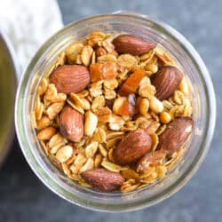 a jar of olive oil granola with almonds.