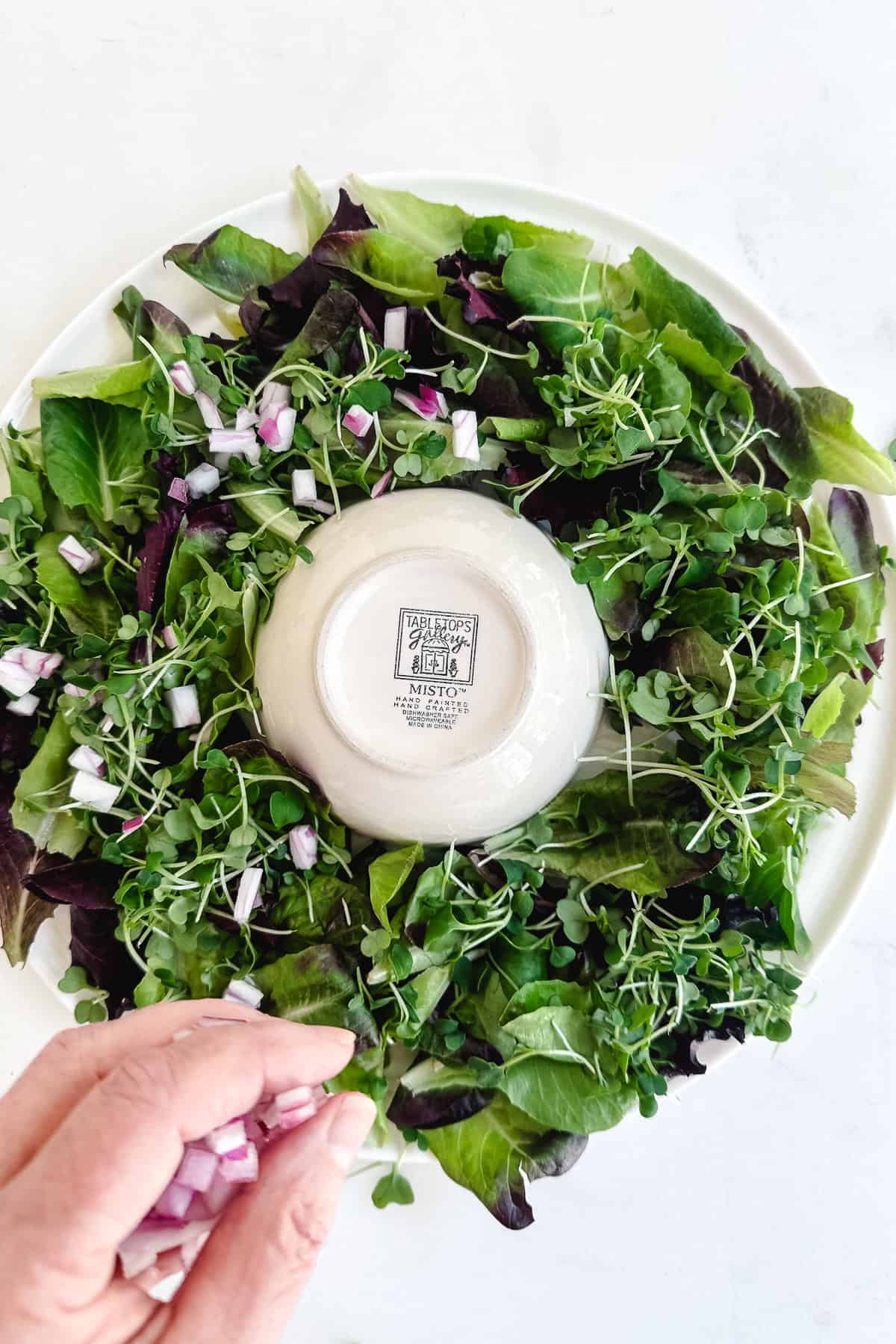 Addig toppings to a wreath salad.