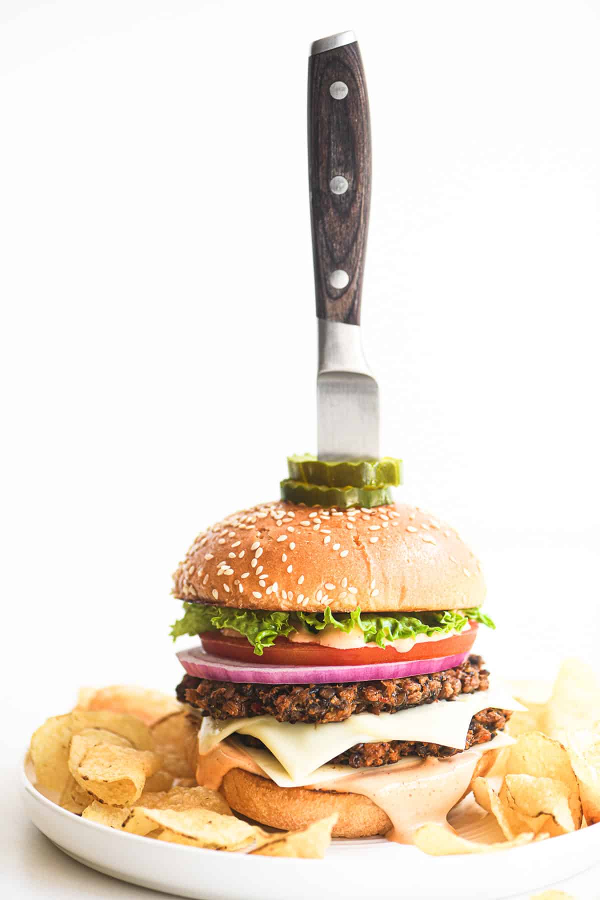 veggie smash burger with knife stuck in the bun.