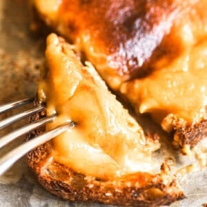 Cutting into a slice of Welsh rarebit.